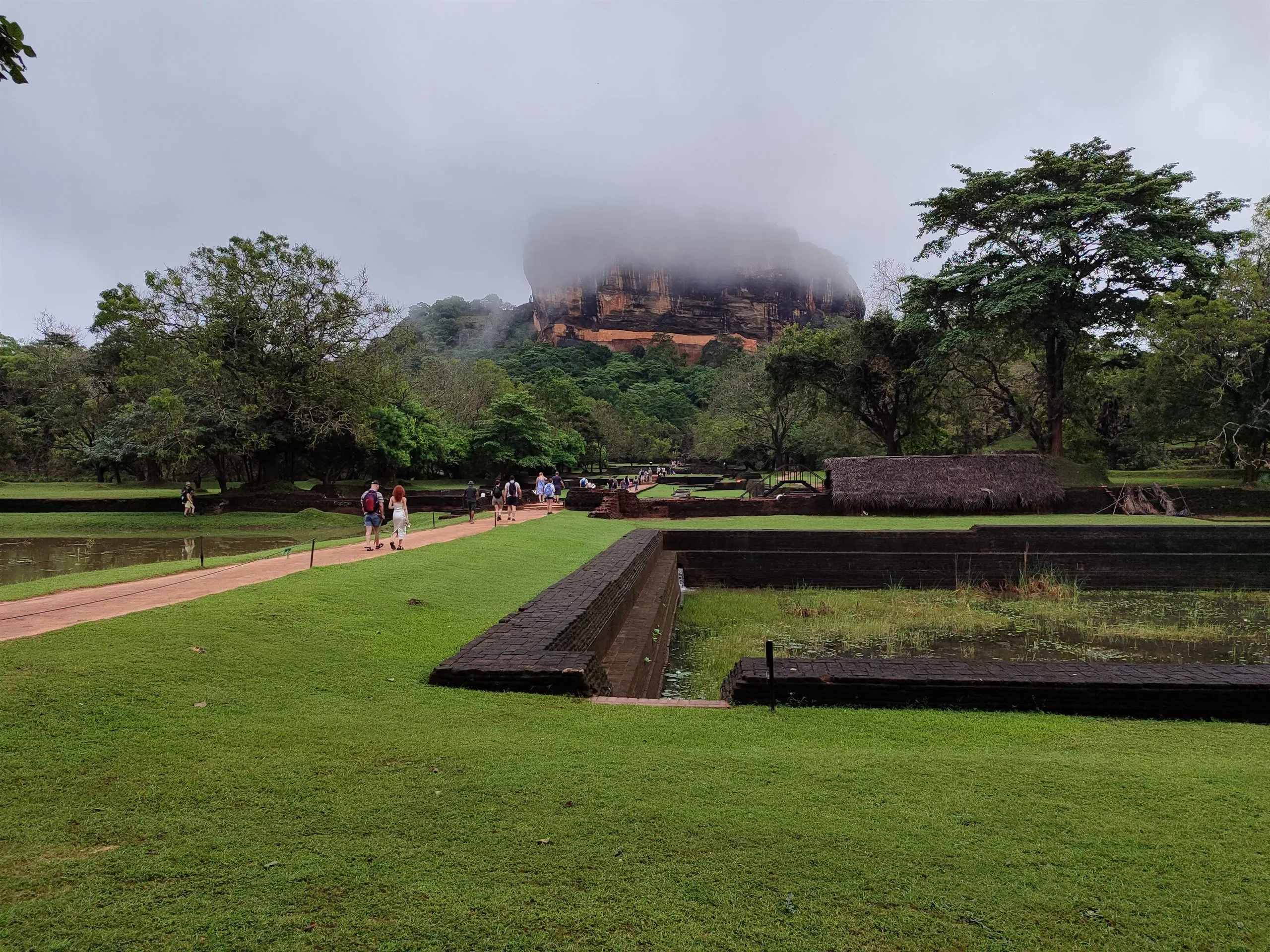 Sigiriya rock in mist, seen across the old water gardens