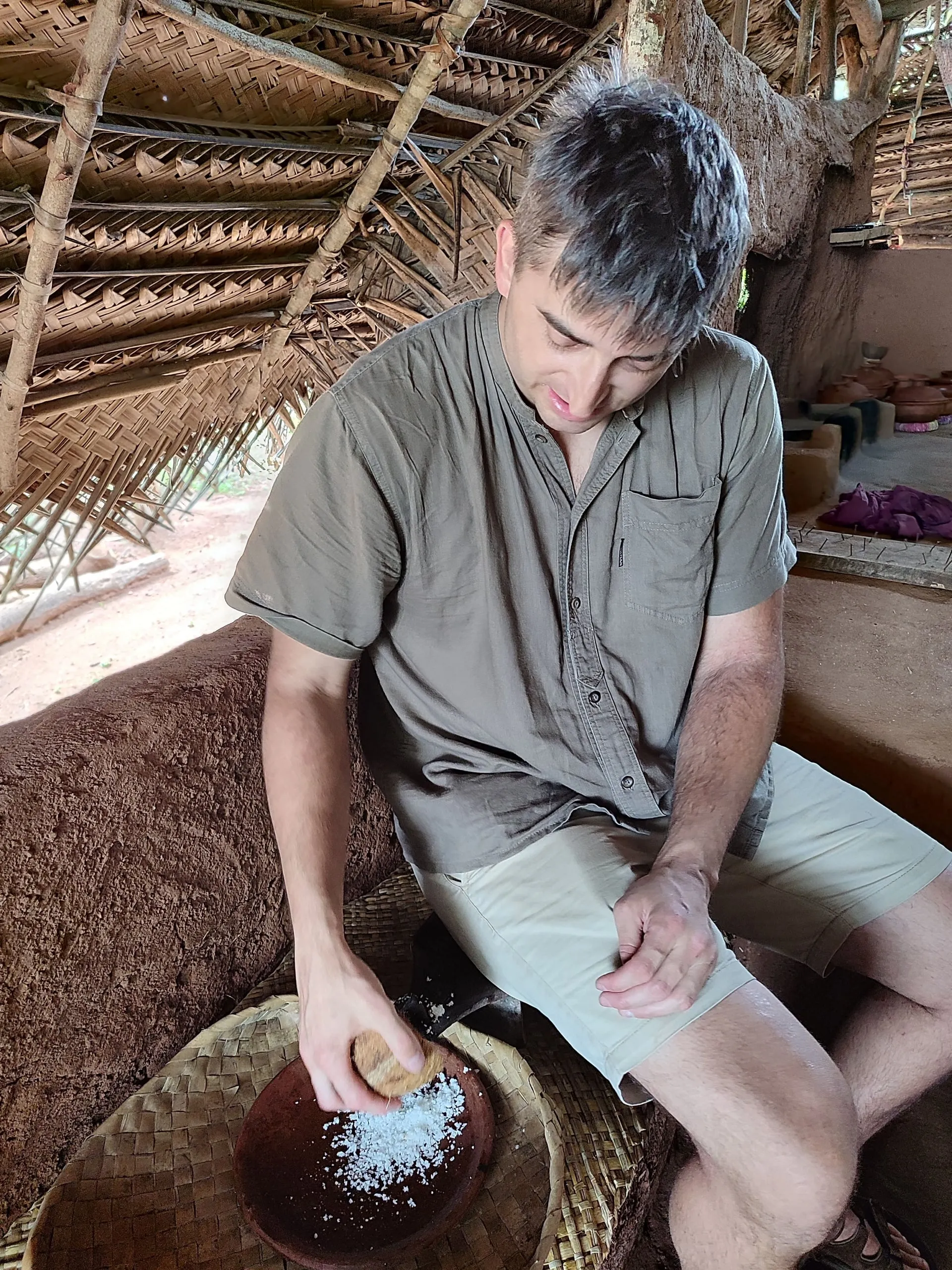 Grating fresh coconut by hand at a village house