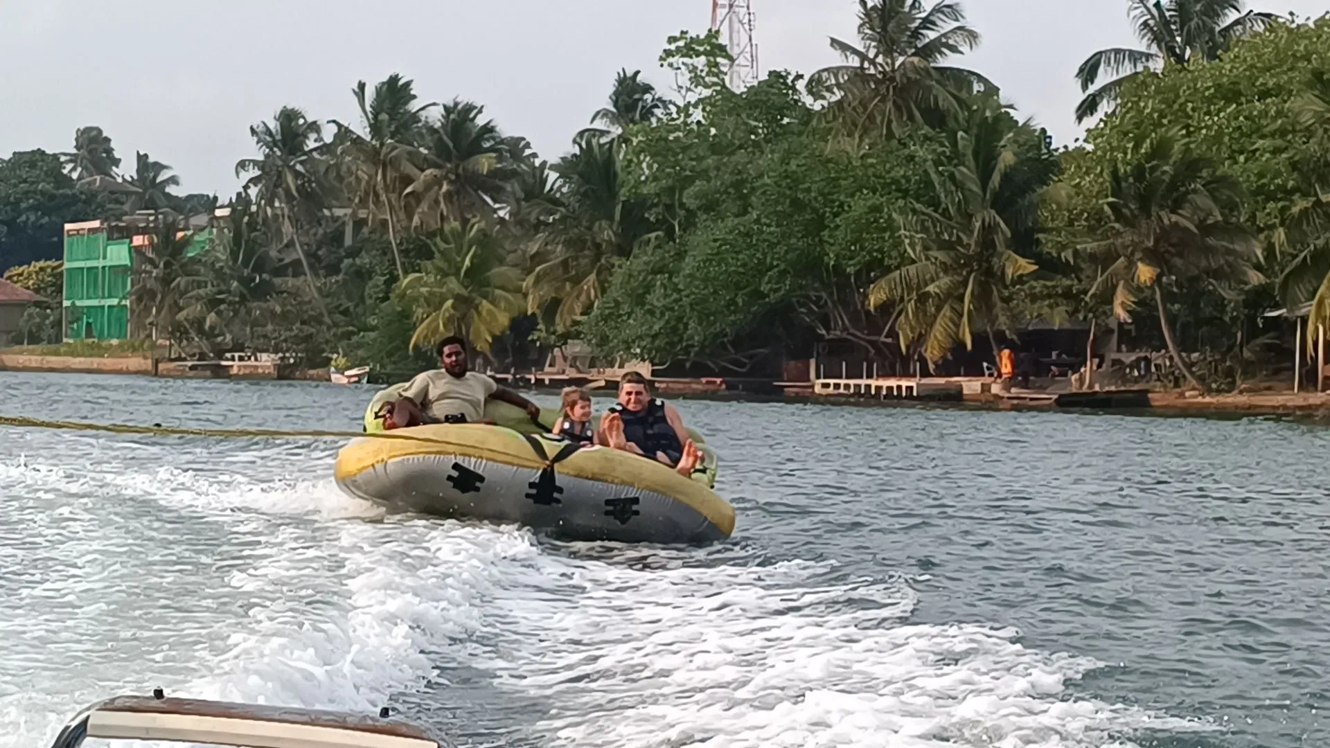 Guests on a towed inflatable ring on the Bentota river
